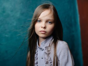 cute little girl in dress posing sad look